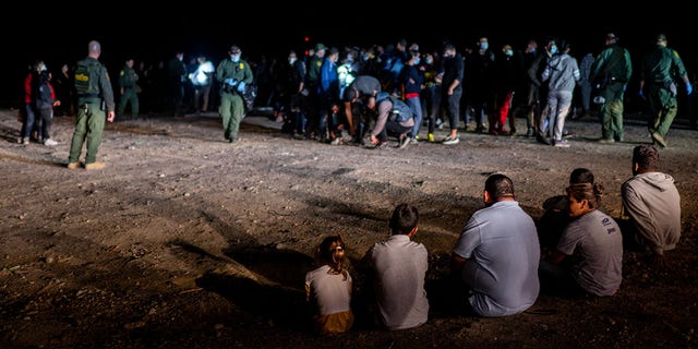 May 5, 2022: A migrant family sits after being processed in Roma, Texas.(Photo by Brandon Bell/Getty Images)