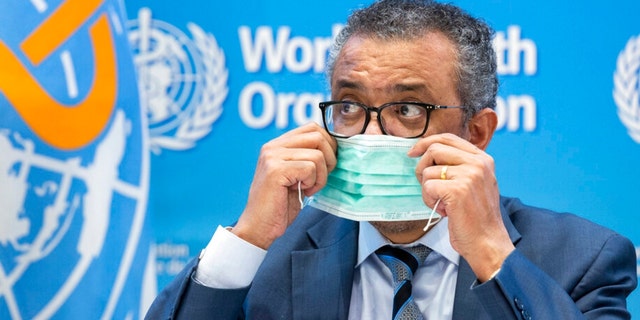 Tedros Adhanom Ghebreyesus, Director General of the World Health Organization (WHO), removes his protective face mask prior to speaking to the media at the World Health Organization (WHO) headquarters in Geneva, Switzerland, on Dec. 20, 2021.