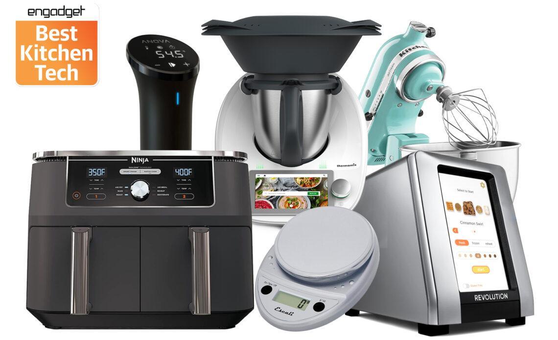 A bunch of kitchen gadgets, including an air fryer, a food scale, a sous vide machine, a smart toaster and a KitchenAid stand mixer against a white background.
