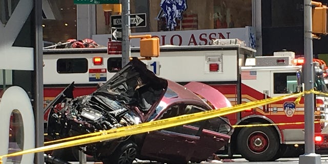 A smashed car sits on the corner of Broadway and 45th Street in New York's Times Square after driving through a crowd of pedestrians