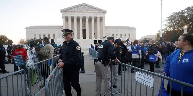 Supreme Court Police officers erect a barrier between anti-abortion and pro-abortion rights protesters outside the court building, ahead of arguments in the Mississippi abortion rights case Dobbs v. Jackson Women's Health, in Washington, U.S., December 1, 2021. REUTERS/Jonathan Ernst
