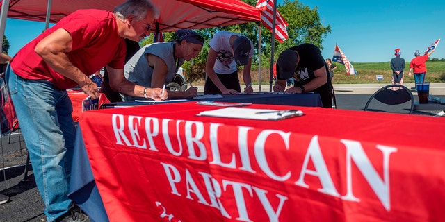 People register to vote during a Republican voter registration in Brownsville, Pennsylvania on September 5, 2020.
