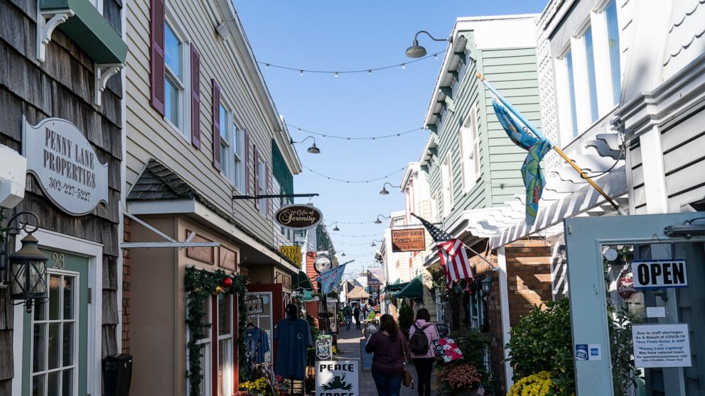 FILE - People walk by shops Nov. 13, 2020, in Rehoboth Beach, Del. The Friday June 10, 2022, report on consumer prices is expected to show that annual inflation slowed ever so slightly to 8.2% in May from 8.3% in the prior month. President Joe Biden