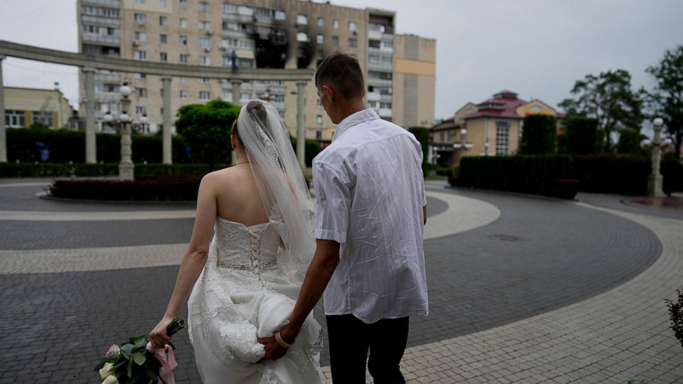 Yevhen Levchenko and Nadiia Prytula leave after getting married in Irpin, on the outskirts of Kyiv, Ukraine, Tuesday, June 21, 2022. After the wedding the couple must separate, Nadiia goes to study abroad and Yevhen stays because men cannot leave the