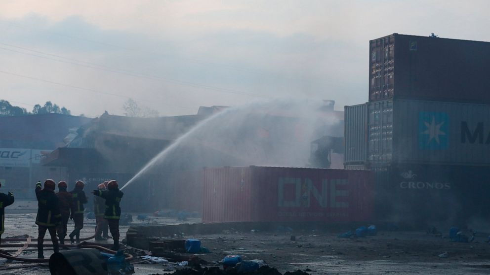 Firefighters work to contain a fire that broke out at the BM Inland Container Depot, a Dutch-Bangladesh joint venture, in Chittagong, 216 kilometers (134 miles) southeast of capital, Dhaka, Bangladesh, early Sunday, June 5, 2022. Several people were