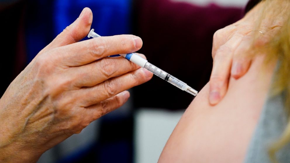 FILE - A health worker administers a dose of a COVID-19 vaccine during a vaccination clinic at the Keystone First Wellness Center in Chester, Pa., on Dec. 15, 2021. Government advisers are debating Tuesday, June 28, 2022, if Americans should get a mo