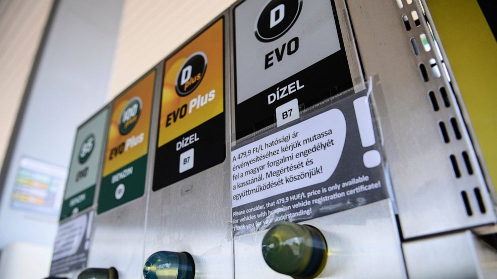 An sign at a petrol station gives information on the discount of fuel, in Budapest, Hungary, Sunday, June 12, 2022. Hungary has placed price caps on fuel and some food and imposed special taxes on industries as the government tries to ease an economi