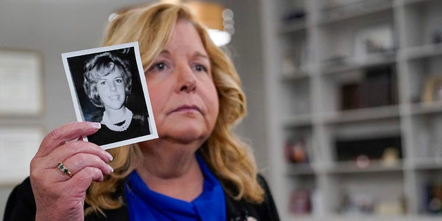 Nassau County District Attorney Anne Donnelly holds a photo of Diane Cusick during an interview with The Associated Press, Wednesday, June 22, 2022, in Mineola, N.Y.