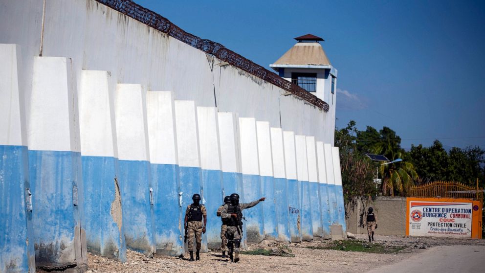 FILE - National police search for escaped inmates on the perimeters of the Croix-des-Bouquets Civil Prison in Port-au-Prince, Haiti, Feb. 25, 2021. The United Nations Security Council released a report in June 2022 saying 54 prison deaths related to