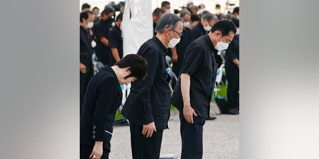 Japan's Prime Minister Fumio Kishida, right, offers a silent prayer during a ceremony at the Peace Memorial Park in Itoman, Okinawa, southern Japan Thursday, June 23, 2022. Japan marked the Battle of Okinawa, one of the bloodiest battles of World War II fought on the southern Japanese island, which ended 77 years ago, Thursday. 