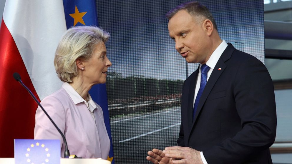 Polish President Andrzej Duda, right, and European Commission President Ursula von der Leyen speak after at a joint news conference with Poland's Prime Minister Mateusz Morawiecki at the headquarters of Poland's Power Grid in Konstancin-Jeziorna, Pol