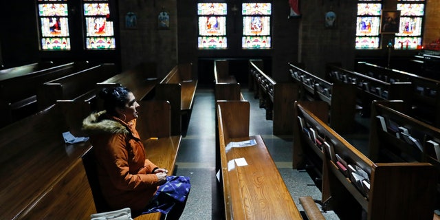 Parishioner Maria Torres of Des Moines, Iowa, prays the Rosary in an empty St. Anthony's Catholic Church March 27, 2020, in Des Moines, Iowa. 