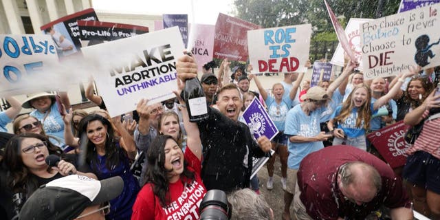 Pro-life advocates celebrate, Friday, June 24, 2022, outside the Supreme Court in Washington. The Supreme Court has ended constitutional protections for abortion that had been in place nearly 50 years, a decision by its conservative majority to overturn the court's landmark abortion cases.