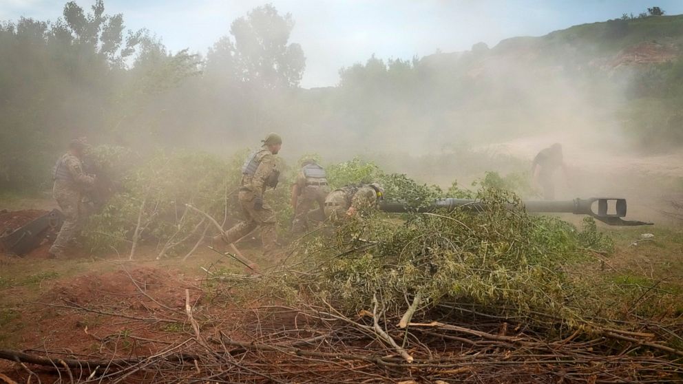 Ukrainian soldiers camouflage a U.S.-supplied M777 howitzer with tree branches after they fired at Russian position in Ukraine's eastern Donetsk region Saturday, June 18, 2022. (AP Photo/Efrem Lukatsky)