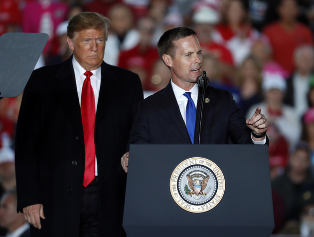President Donald Trump listens as U.S. Rep. Rodney Davis (R-Ill.) speaks during a rally at Southern Illinois Airport Saturday, Oct. 27, 2018, in Murphysboro, Ill.
