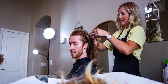 Matt Shaha chops off his hair to make his mom, Melanie, a wig.