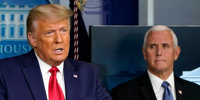In this Nov. 24, 2020, file photo, President Trump speaks in the press briefing room as Vice President Mike Pence listens in Washington. 