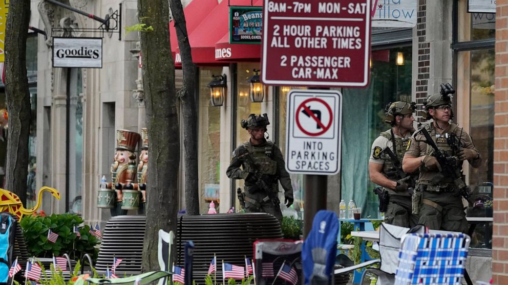 Law enforcement search after a mass shooting at the Highland Park Fourth of July parade in downtown Highland Park, Ill., a Chicago suburb on Monday, July 4, 2022. (AP Photo/Nam Y. Huh)