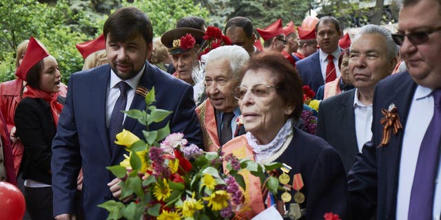 Denis Pushilin, left, joins the commemoration of VE Day on May 9, 2015, in Donetsk, Ukraine.