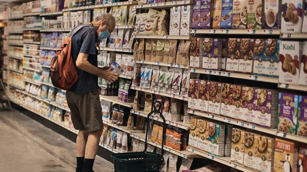 A man shops at a supermarket on Wednesday, July 27, 2022, in New York. The Federal Reserve on Wednesday raised its benchmark interest rate by a hefty three-quarters of a point for a second straight time in its most aggressive drive in three decades t