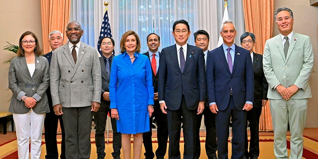 U.S. House Speaker Nancy Pelosi, front, center left, and her congressional delegation pose for a photo with Japanese Prime Minister Fumio Kishida, center right, before their breakfast meeting at the prime minister's official residence in Tokyo.