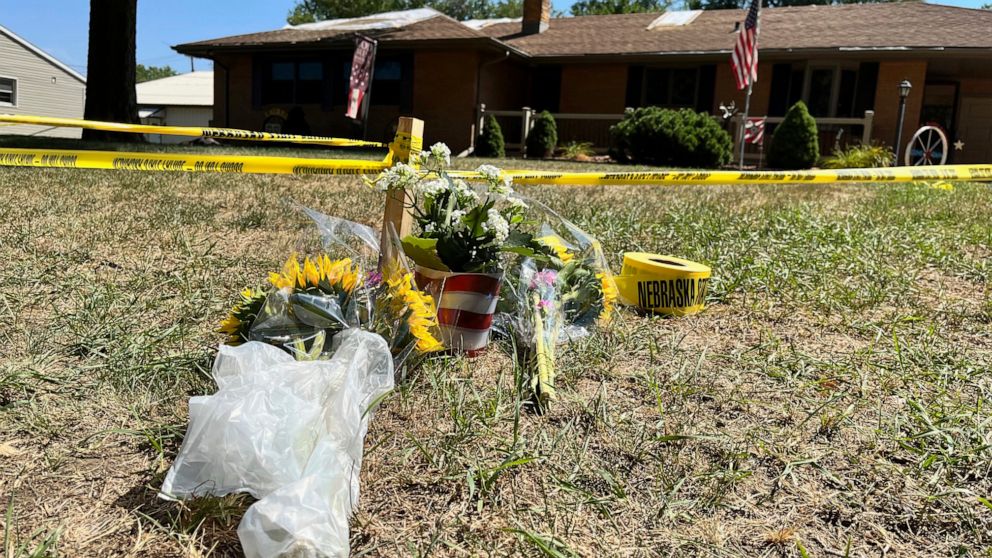A small memorial sits outside the home of Gene Twiford, 86, Janet Twiford, 85, and Dana Twiford, 55, Friday, Aug. 5, 2022, in Laurel, Neb. The three were among four people found dead Thursday in two burning homes in this small community in northeaste