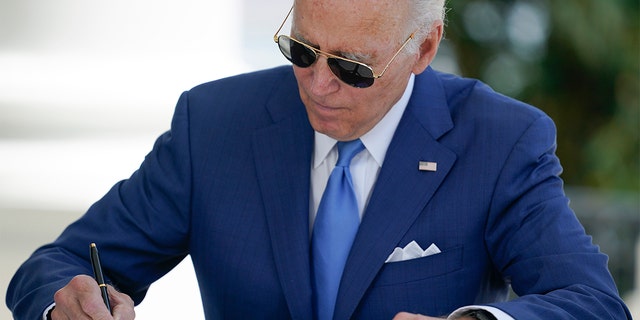 President Biden signs two bills aimed at combating fraud in the COVID-19 small business relief programs at the White House in Washington on Friday, Aug. 5, 2022.