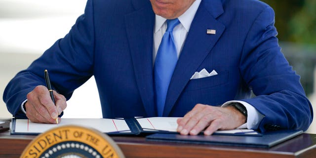 President Joe Biden signs bills on Friday, Aug. 5, 2022, at the White House in Washington. 