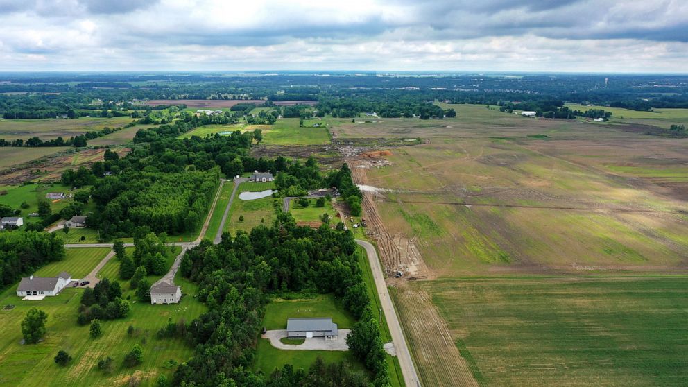 FILE - This aerial image taken with a drone on June 9, 2022 shows a portion of land in Johnstown, Ohio, where Intel plans to build two new processor factories. The houses on the left are up for demolition. Intel Corp. plans a Sept. 9 groundbreaking f