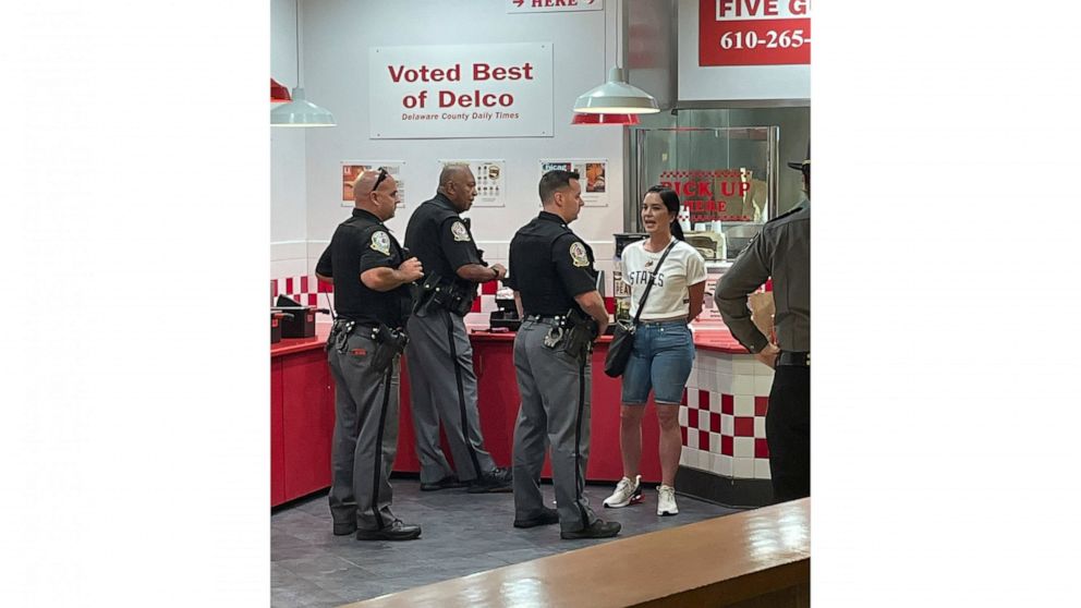 In this photo provided by Corey Cohen, a woman was handcuffed and taken into custody after pulling out a gun during a dispute in a food court at the King of Prussia mall according to police on Thursday, Aug. 25, 2022, in Upper Marion, Pa. (Corey Cohe