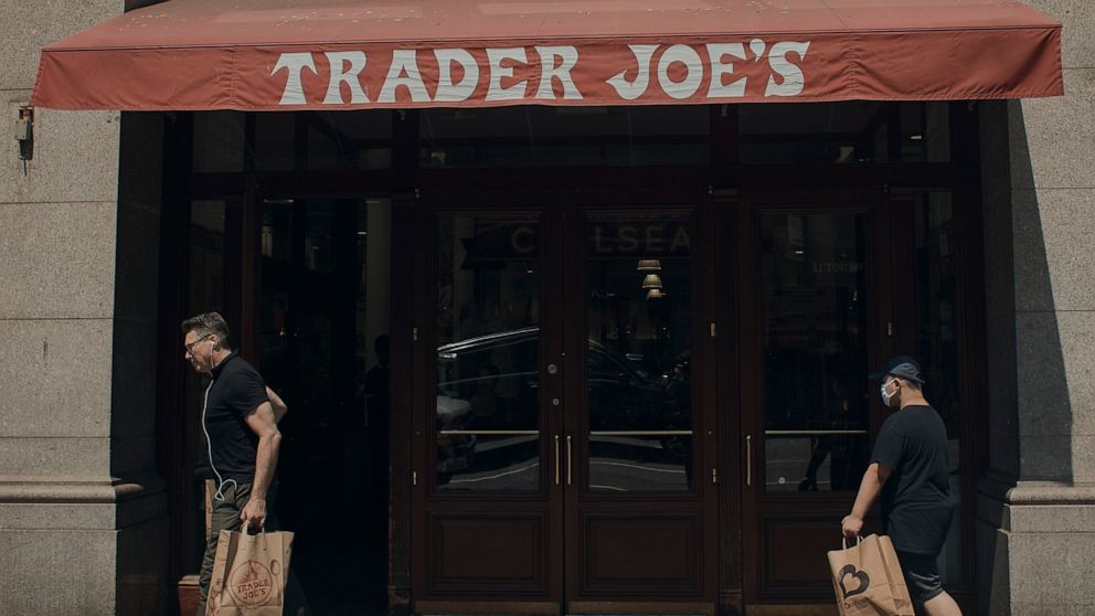 People shop at a supermarket on Wednesday, July 27, 2022 in New York. The Federal Reserve on Wednesday raised its benchmark interest rate by a hefty three-quarters of a point for a second straight time in its most aggressive drive in three decades to