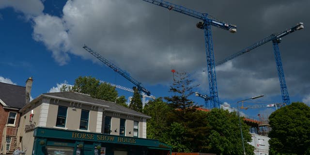 Construction cranes over a new corporative offices construction site next to the Horse Show House in Ballsbridge area of Dublin. 