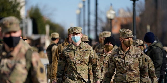 Members of the DC National Guard walk around the U.S. Capitol grounds. (AP Photo/Julio Cortez)
