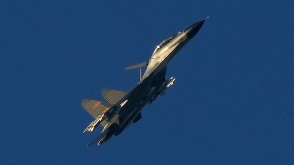 A Chinese J-11 military fighter jet flies above the Taiwan Strait near Pingtan, the closest land of mainland China to the island of Taiwan, in Pingtan in southeastern China's Fujian Province, Friday, Aug. 5, 2022. China says it is canceling or suspen