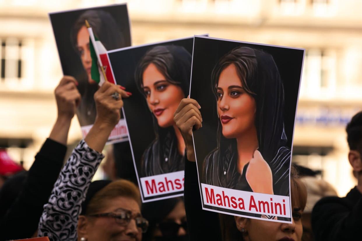 Posters of Mahsa Amini are seen in front of Dom Cathedral in Cologne, Germany