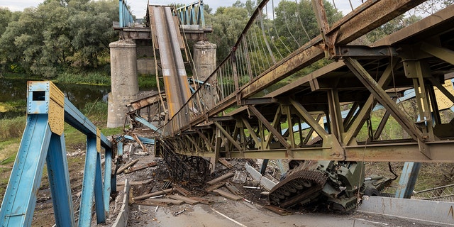 A Russian tank and a destroyed bridge are seen in Izium, Ukraine, on Tuesday. Izium had been occupied by Russians since April 1, causing major destruction and death to the small city.