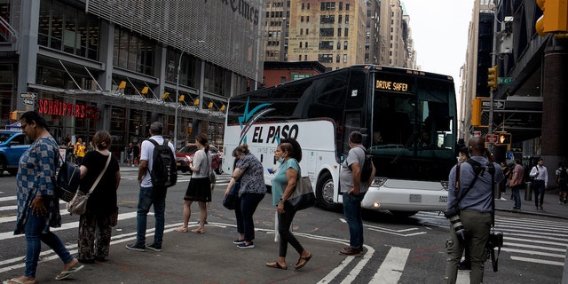 A bus from Texas carrying migrants arrives in New York City.