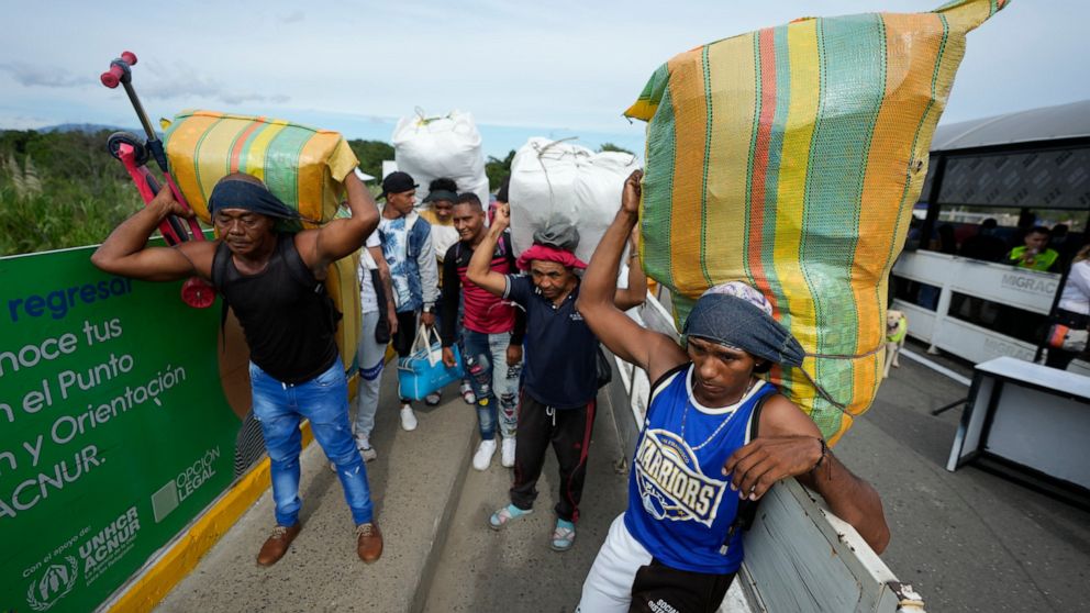 Venezuelans wait briefly on the Simon Bolivar International Bridge cross from Cucuta, Colombia to San Antonio del Tachira, Venezuela, Monday, Sept. 26, 2022. In a ceremonial act to mark the resumption of commercial relations between the two nations,