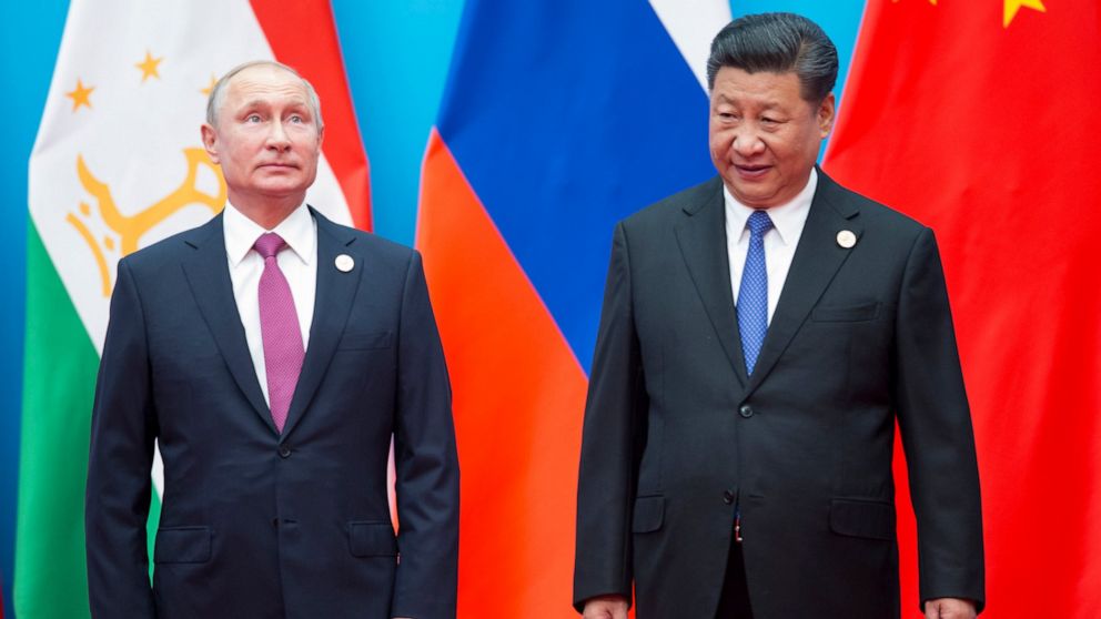 FILE - Chinese President Xi Jinping, right, and Russian President Vladimir Putin pose for a photo at the Shanghai Cooperation Organization (SCO) Summit in Qingdao in eastern China's Shandong Province on June 10, 2018. President Xi Jinping is using hi