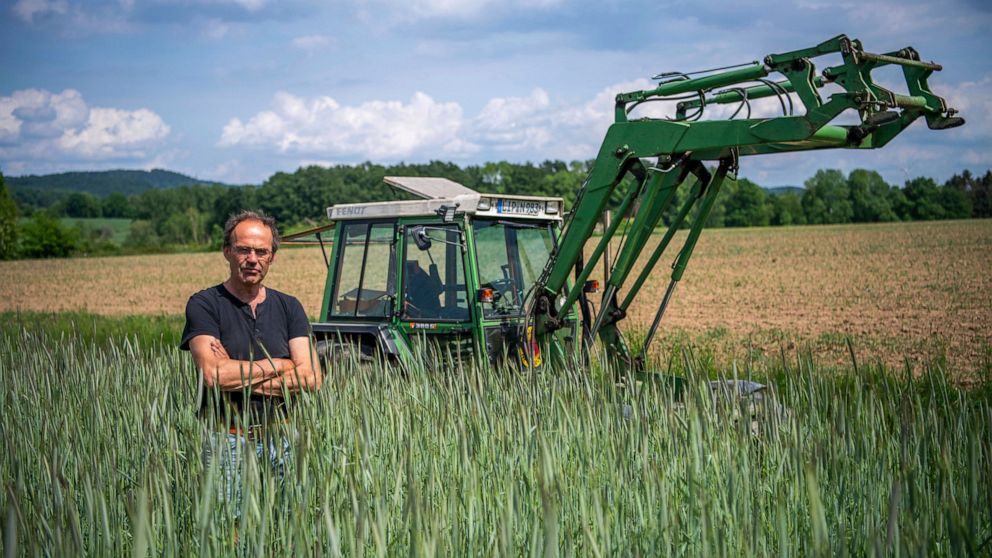 FILE - Ulf Allhoff-Cramer, farmer, stands in a rye field in front of his tractor in Detmold, Germany, on May 18, 2022. Environmentalists claimed a small legal victory Friday, Sept. 9, 2022, after a court in Germany said it would continue hearing a ca