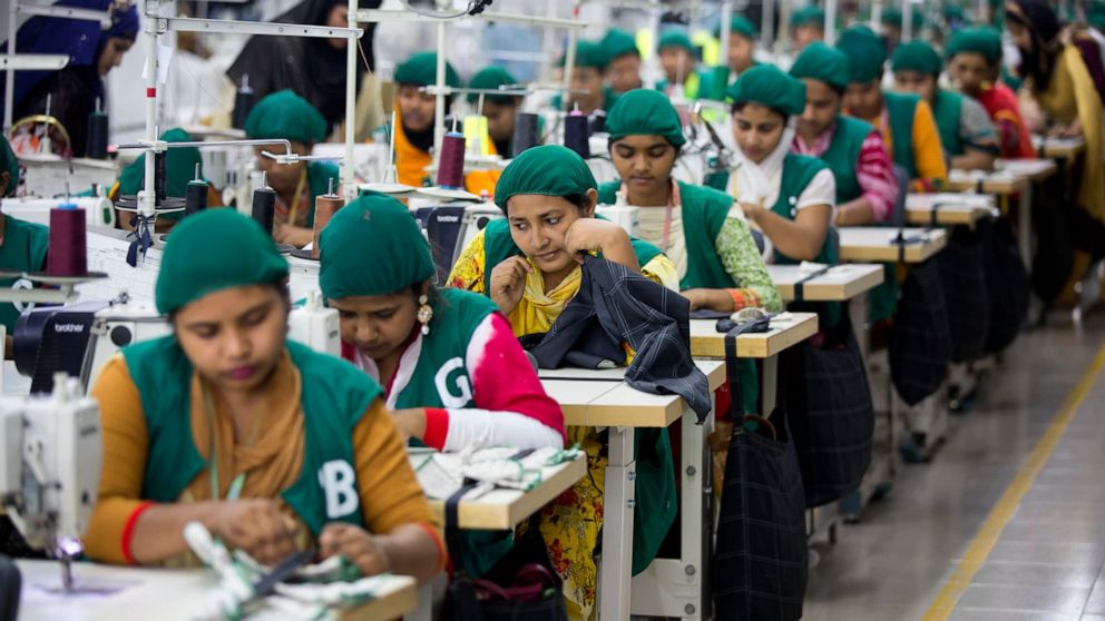 FILE - Trainees work at Snowtex garment factory in Dhamrai, near Dhaka, Bangladesh, April 19, 2018. Bangladesh's economic miracle is under severe strain as fuel price hikes amplify public frustrations over rising costs for food and other necessities.