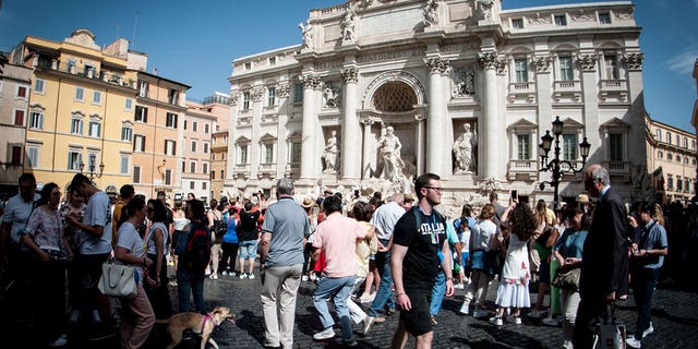 Italy may see a smaller population in the next 50 years, statistic agency ISTAT said. Pictured: A crowd in front of the Trevi Fountain square in Rome, Italy, on June 3, 2022.