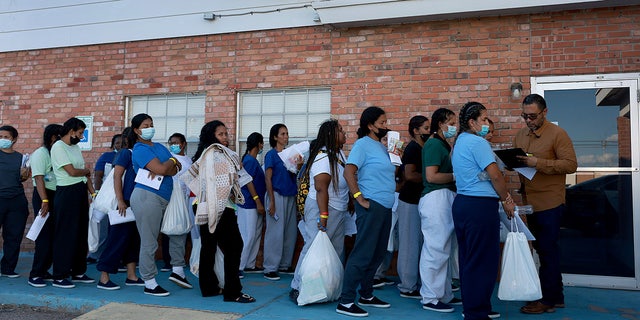 Migrants who recently arrived from Venezuela after crossing from Mexico wait to be assigned a hotel room provided by the El Paso Office of Emergency Management on Sept. 21, 2022, in El Paso, Texas. 