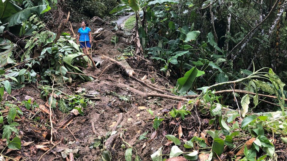 Nancy Galarza looks at the damage that Hurricane Fiona inflicted on her community, which remained cut off four days after the Category 1 storm slammed the rural community of San Salvador in the town of Caguas, Puerto Rico, Thursday, Sept. 22, 2022. (