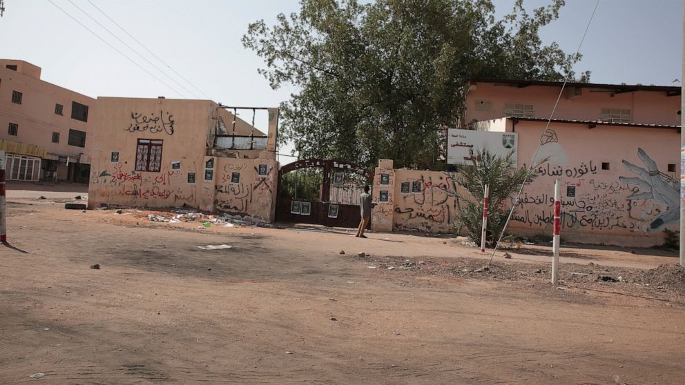 People walk outside a hospital in Khartoum, Sudan, Tuesday, Sept. 27, 2022. Sudanese medical officials warned Monday that more than 1,500 unidentified bodies piled up in several of the country’s morgues could lead to an outbreak of disease, amid accu