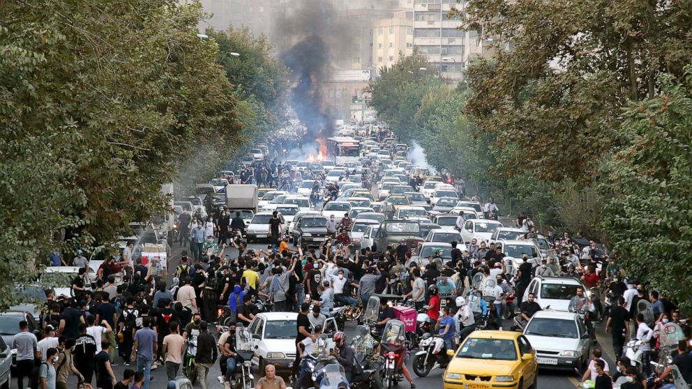 FILE - In this photo taken by an individual not employed by the Associated Press and obtained by the AP outside Iran, protesters chant slogans during a protest over the death of a woman who was detained by the morality police, in downtown Tehran, Ira