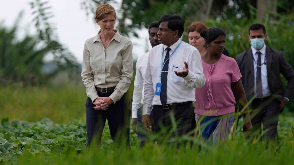 USAID administrator Samantha Power, left, speaks with agriculture specialists of UN's FAO and rice farmers during a visit to a paddy field in Ja-Ela on the outskirts of Colombo, Sri Lanka, Saturday, Sept. 10, 2022. (AP Photo/Eranga Jayawardena)