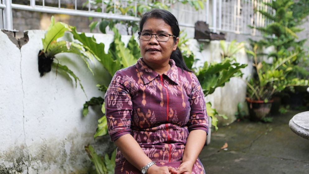 Bali bombing survivor Thiolina Marpaung poses for a photograph during an interview with The Associated Press in Denpasar in Bali, Indonesia, on Oct. 3, 2022. Marpaung was in a car with her colleagues on the Indonesian resort island of Bali in 2002 wh