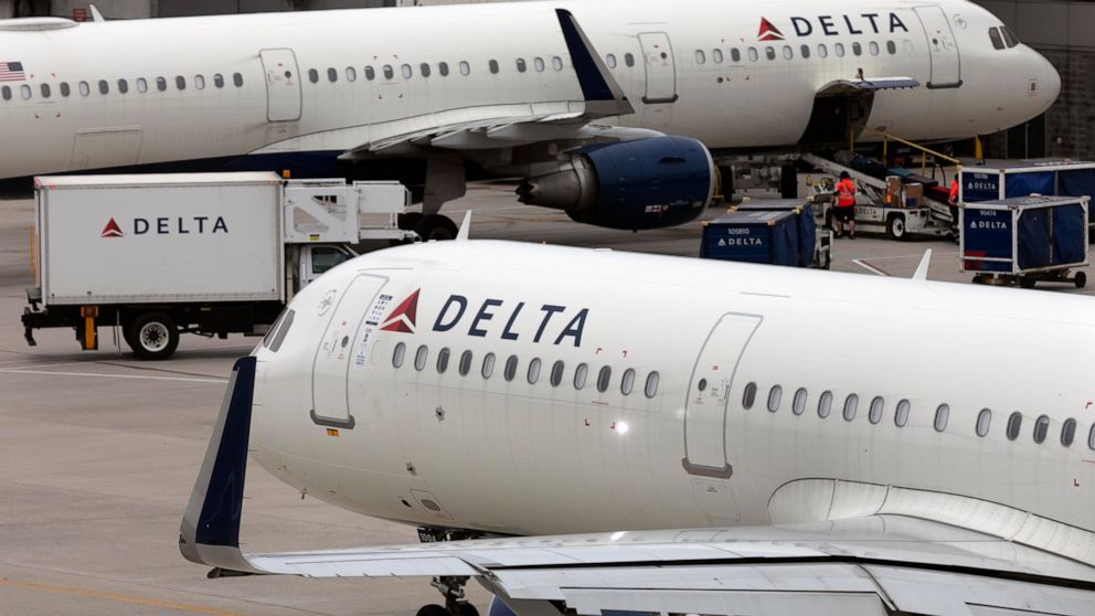 FILE - A Delta Air Lines plane leaves the gate on July 12, 2021, at Logan International Airport in Boston. Delta Air Lines announced Tuesday, Oct. 11, 2022, that it has invested $60 million in a startup that hopes to build electric helicopter-like ai