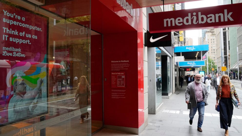 People walk past a Medibank branch in Sydney, Thursday, Oct. 20, 2022. Medibank health insurer is being extorted for customers' data in the nation's second major cybersecurity breach in a month, an official says. (AP Photo/Rick Rycroft)